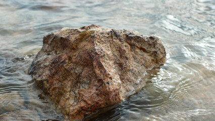 Stones on the shore of Lake Villeneuve-de-la-Raho, France, close-up, vacation, holidays, nature of Europe, water
