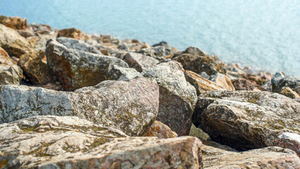 Stones on the shore of Lake Villeneuve-de-la-Raho, France, close-up, vacation, holidays, nature of Europe, water