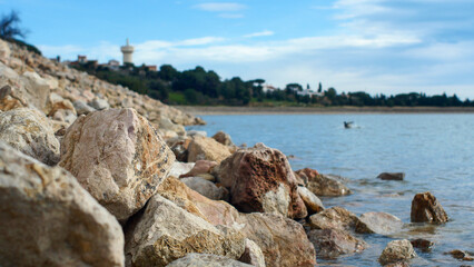 Stones on the shore of Lake Villeneuve-de-la-Raho, France, close-up, vacation, holidays, nature of Europe, water