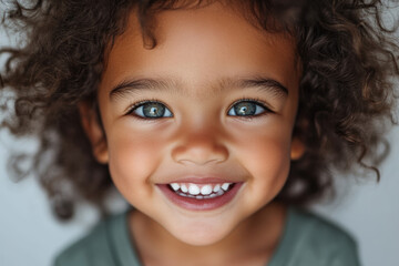 Fototapeta premium Joyful Child with Curly Hair and Bright Eyes 
