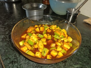 A tangy and spicy homemade mango pickle made with raw mangoes, mustard seeds, and a blend of Indian spices, marinated to perfection in oil and spices for a bold flavor.