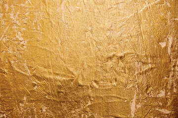 Textured golden stucco background with scratches