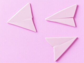 Three Pink Paper Airplanes on Pink Background