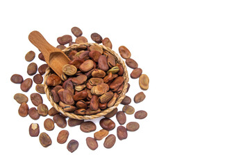 A wicker bowl full of dried broad beans on a white background with copy space