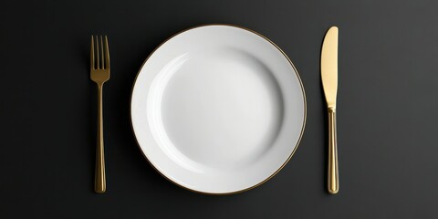 Elegant dining setup with a white plate and gold cutlery on a dark background