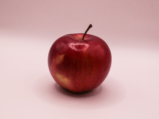 Ripe red apple, on a light background, side view