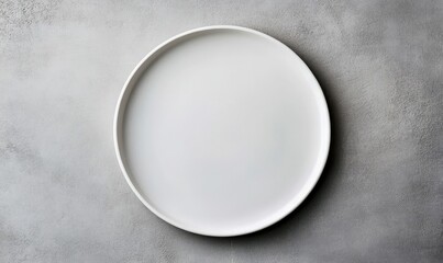 A pristine white plate sits on a textured grey background, ready for your culinary creations.