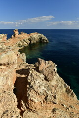 Cap Martinet, Ibiza, Balearic Islands, Spain. A natural coastal landscape in sunny calm weather.