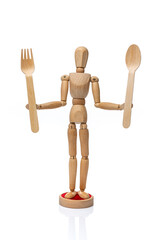 Wooden toy mannequin  holding disposable wooden fork and spoon on a white background.