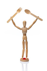 Wooden toy mannequin  holding disposable wooden fork and spoon on a white background.