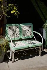 antique metal glider in the back yard