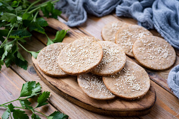 Rye cakes on a wooden background. Home cooking: rye tortillas on a plate. Close-up