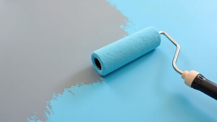 Obraz premium Close-up of paint roller applying fresh color to gray surface, showcasing home improvement and renovation process in action.