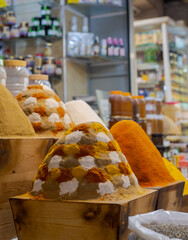 Colourful herbs and spices for sale in the souk bazaar in Meknes, Morocco. Photographed in the kissaria, covered market.