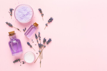 Lavender spa cosmetic on color background, top view