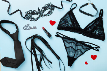 Set of erotic accessories on color background, top view
