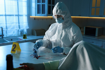 Forensic expert taking blood sample and dead woman's body at countertop indoors