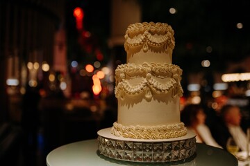 Elegant Three-Tiered Wedding Cake with Intricate Decoration