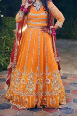 "Golden Tangerine Elegance: A Bride’s Radiance in Luxurious Orange Attire"
