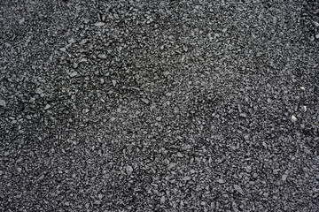 Close-up of rough asphalt pavement texture
Detailed view of coarse asphalt surface, showing compacted gravel and bitumen mix typical of roads, driveways, or parking areas.
