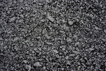 Close-up of rough asphalt pavement texture
Detailed view of coarse asphalt surface, showing...