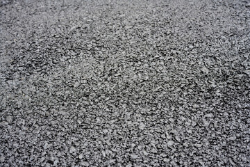 Close-up of rough asphalt pavement texture
Detailed view of coarse asphalt surface, showing...