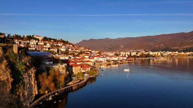 Drone shot of Ohrid boardwalk and Lake Ohrid revealing the old town of Ohrid