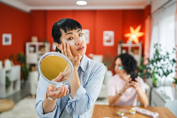 delight mature japanese woman with eye patches look in the mirror
