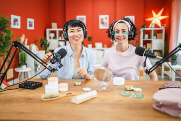 Fototapeta premium female friends review and rated skincare product in the podcast