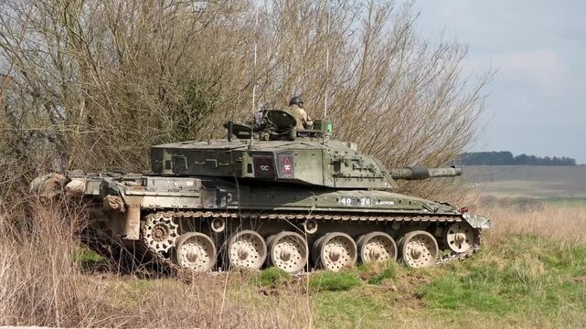 commander and gunner directing Challenger 2 II tank FV4034 in action on a military exercise