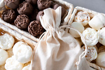 Assorted handmade soaps in wicker baskets with linen bag display