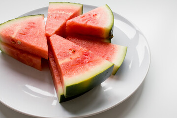 Juicy slices of fresh watermelon on white plate
