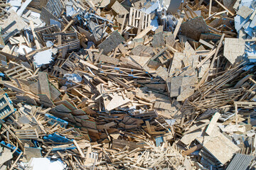 A pile of wood and debris with a lot of boards scattered around