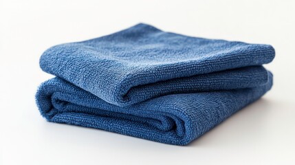 Two folded blue microfiber cloths displayed on plain white background. Cloths texture evident, looks soft. Cleaning cloth suitable for kitchen household cleaning task. Top view closeup.