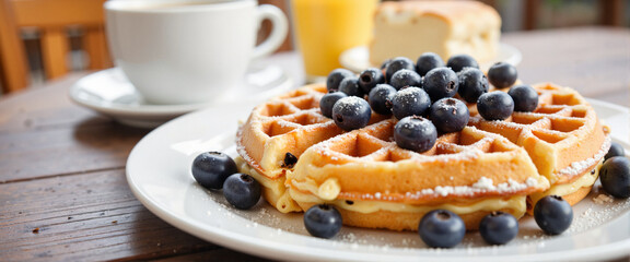 Delicious Belgian waffles topped with blueberries, inviting brunch setting