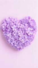 Fototapeta premium Lavender heart-shaped flower arrangement on soft pink background