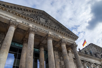 Berlin, Germany 03. October 2024, Reichstag building facade with german flag waving in Berlin