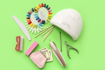 Composition with supplies for manicure, wallet and money on green background
