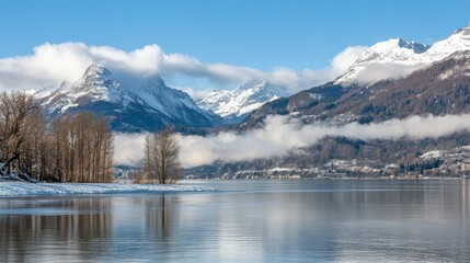 Snow-capped mountains behind a peaceful lake on a beautiful sunny winter day.