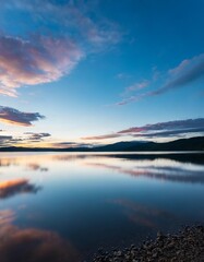 Fototapeta premium Ripples on a Still Lake Mirroring the Graceful Dance of Twilight Clouds