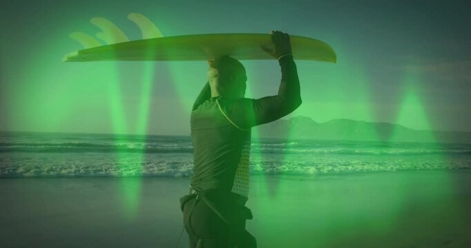 Surfer holding board over head with green light animation on beach