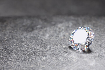 Beautiful shiny gemstone on stone, space for text