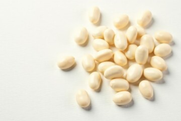 Scattered white beans on pure white background, simple, photography