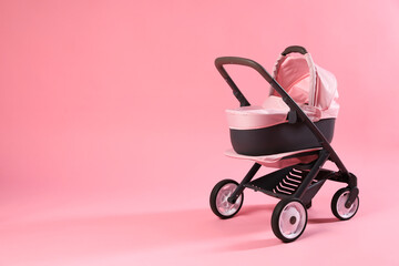 Stylish doll stroller on pink background, space for text. Kid's toy