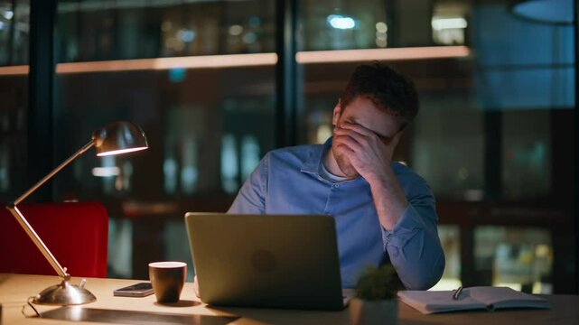 Stressed man failing startup feeling despair in night office workplace closeup.