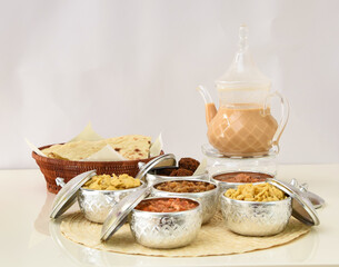 Traditional Middle Eastern Breakfast with Flatbread, Falafel, Assorted Dishes, and Karak Tea in Elegant Setup side view