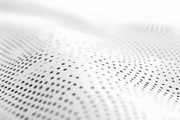 White perforated surface with dynamic wave pattern and blurred background for technology concept