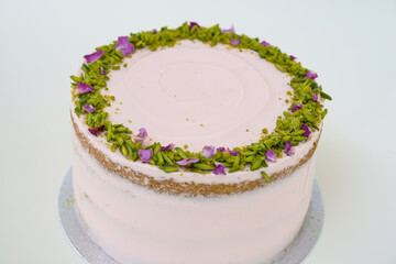 Pistachio Rose Cake with floral decor, pistachio and rose petal garnish side view of dessert elegant cake perfect for celebrations