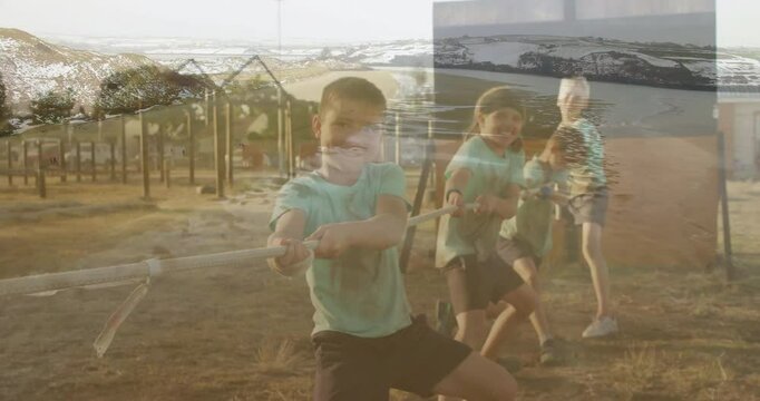 In school, children playing tug-of-war with animation of beach and ocean waves