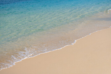 Nature of the beach and sea Summer with sunshine, sandy beaches, clear blue waters sparkling against the blue sky. On an island with good ecology and environment Background for summer vacation